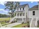 Charming two-story home with a white garage, inviting porch, and meticulously landscaped front yard at 3029 Robeson Trce, Johns Island, SC 29455