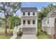 Charming two-story home with a white garage, inviting porch, and meticulously landscaped front yard at 3029 Robeson Trce, Johns Island, SC 29455