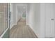 Bright hallway with light hardwood flooring and a glimpse into a spacious, sunlit interior at 3029 Robeson Trce, Johns Island, SC 29455