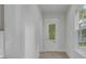 Bright hallway with light hardwood flooring and a door with glass panes at 3029 Robeson Trce, Johns Island, SC 29455