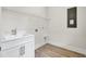 Functional laundry room area with a sink, storage shelves, and bright lighting at 3029 Robeson Trce, Johns Island, SC 29455
