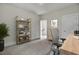 Bright home office with bookshelf and adjacent staircase with natural light at 3029 Robeson Trce, Johns Island, SC 29455