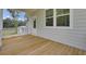 Empty porch with wooden flooring and siding, offering an inviting outdoor space at 3029 Robeson Trce, Johns Island, SC 29455
