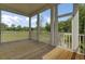 Screened porch with wood flooring overlooking backyard trees and landscaping at 3029 Robeson Trce, Johns Island, SC 29455