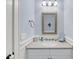 Bathroom featuring a framed mirror, towel ring, single sink, and under sink storage at 3126-B Palmetto Blvd # 4, Edisto Island, SC 29438