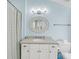 Bright blue bathroom featuring a toilet, vanity, mirror, shower with curtain and coordinated décor at 3126-B Palmetto Blvd # 4, Edisto Island, SC 29438