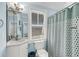 Bright blue bathroom featuring a toilet, sink, vanity, mirror, window with blinds and coordinated décor at 3126-B Palmetto Blvd # 4, Edisto Island, SC 29438