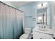 Bright blue bathroom with toilet, sink, mirror, shower with patterned curtain and coordinated décor at 3126-B Palmetto Blvd # 4, Edisto Island, SC 29438