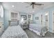 Light blue bedroom with twin beds, a ceiling fan, two bright windows, white trim and classic decor at 3126-B Palmetto Blvd # 4, Edisto Island, SC 29438