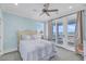 This bedroom has a ceiling fan and sliding glass doors leading to a beachfront balcony at 3126-B Palmetto Blvd # 4, Edisto Island, SC 29438