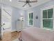 This bedroom has wood floors, a dresser, and two windows at 3126-B Palmetto Blvd # 4, Edisto Island, SC 29438