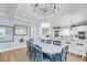 Coastal dining area with ship wheel decor, bright lighting, and open flow to kitchen features a large dining table at 3126-B Palmetto Blvd # 4, Edisto Island, SC 29438