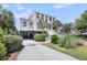 Charming beach house with ample parking, lush landscaping, and coastal-inspired architecture at 3126-B Palmetto Blvd # 4, Edisto Island, SC 29438