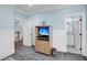 Hallway featuring wood floors, and a cabinet and TV, with an adjoining bathroom with coordinated decor at 3126-B Palmetto Blvd # 4, Edisto Island, SC 29438