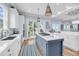 Coastal kitchen with island cooktop, stainless appliances, and access to outdoor deck for al fresco dining at 3126-B Palmetto Blvd # 4, Edisto Island, SC 29438