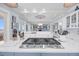 Kitchen view featuring an island cooktop, bar seating, and bright lighting open to other living spaces at 3126-B Palmetto Blvd # 4, Edisto Island, SC 29438