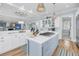 Open-concept kitchen featuring an island with cooktop, bar seating, ample counter space and views into living space at 3126-B Palmetto Blvd # 4, Edisto Island, SC 29438