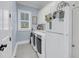 This laundry room has a white fridge and white cabinets at 3126-B Palmetto Blvd # 4, Edisto Island, SC 29438