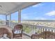 Cozy covered porch with wicker chairs overlooking the beach at 3126-B Palmetto Blvd # 4, Edisto Island, SC 29438