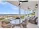 Spacious covered porch with wicker furniture offering stunning beach views at 3126-B Palmetto Blvd # 4, Edisto Island, SC 29438