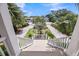 Street view from porch, showing the neighborhood and home's location with palm trees at 3126-B Palmetto Blvd # 4, Edisto Island, SC 29438