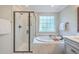 Bathroom featuring soaking tub, glass-enclosed shower, and neutral finishes at 3152 Riverine, Charleston, SC 29414