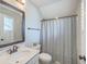 Clean bathroom showcasing a vanity with a framed mirror, a toilet and a shower with a geometric curtain at 3152 Riverine, Charleston, SC 29414