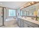 Bright bathroom with double sinks, bathtub, and glass enclosed shower at 3152 Riverine, Charleston, SC 29414