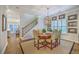 Dining room features a round table, hardwood floors, a modern light fixture and staircase access at 3152 Riverine, Charleston, SC 29414