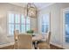 Dining room with a round table and upholstered chairs featuring a modern chandelier at 3152 Riverine, Charleston, SC 29414