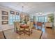 An elegant dining room adjoins the living room featuring a chandelier, natural light and hardwood floors at 3152 Riverine, Charleston, SC 29414