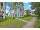 Inviting two-story home with a covered porch and lush green lawn at 3152 Riverine, Charleston, SC 29414