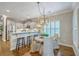 A view of the breakfast bar looking towards the dining area with light fixture and a window with shutters at 3152 Riverine, Charleston, SC 29414