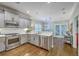A view of the kitchen and the dining area beyond it featuring hardwood floors and stainless steel appliances at 3152 Riverine, Charleston, SC 29414