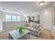 Bright living room featuring a couch, fern, and galley kitchen with stainless steel appliances at 3152 Riverine, Charleston, SC 29414