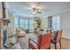Bright living room featuring elegant furnishings, fireplace and bay window with plantation shutters at 3152 Riverine, Charleston, SC 29414