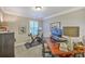 Home office with large desk, chair, Peloton bike, and ample storage at 3152 Riverine, Charleston, SC 29414