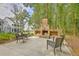 Well-designed outdoor space with a cozy brick fireplace, comfortable seating, and a beautifully landscaped yard at 3152 Riverine, Charleston, SC 29414