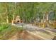 Charming outdoor area featuring a brick fireplace, dining tables, and lush greenery, ideal for outdoor entertaining at 3152 Riverine, Charleston, SC 29414