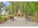 Inviting outdoor space with a large brick fireplace and seating area, perfect for gatherings and relaxation at 3152 Riverine, Charleston, SC 29414