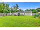 Spacious backyard featuring a lush lawn, a patio set, and a charming garden, perfect for outdoor relaxation at 337 Price St, Goose Creek, SC 29445
