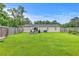 The backyard features a lawn with dining furniture, an umbrella and a garden at 337 Price St, Goose Creek, SC 29445
