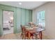 Dining area with a wooden table, seating, and a view into the Primary bedroom at 337 Price St, Goose Creek, SC 29445