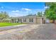 Single story home with a long driveway, gravel parking area, and a large yard at 337 Price St, Goose Creek, SC 29445