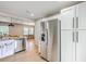 Kitchen with stainless steel appliances, white cabinets, and an open view of the dining area at 337 Price St, Goose Creek, SC 29445