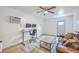 The living room features a leather sofa, ceiling fan, desk, wood flooring, and light gray area rug at 337 Price St, Goose Creek, SC 29445