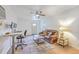 The living room is well lit, and features a ceiling fan, desk, sofa and small coffee table at 337 Price St, Goose Creek, SC 29445