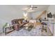 Well lit living room with ceiling fan, desk, sofa, coffee table and staircase in view at 337 Price St, Goose Creek, SC 29445