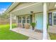 Inviting front porch with cozy seating, potted plants, and a light blue front door at 337 Price St, Goose Creek, SC 29445