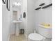 Cozy half bathroom featuring a pedestal sink, neutral tones, and modern floating shelves at 3506 Galaxy Rd, Ladson, SC 29456